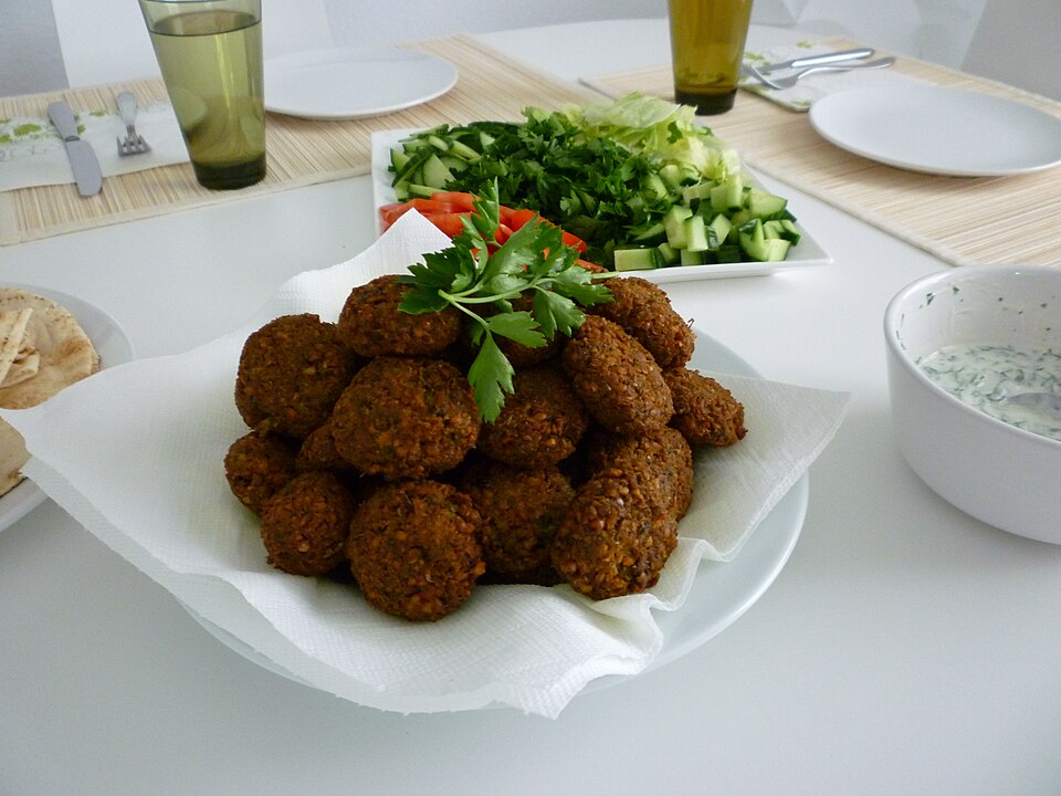 Photo of home made Falafel, an Arabian dish consisting of chickpeas, various spices, deep fried, with some parsley as decoration.